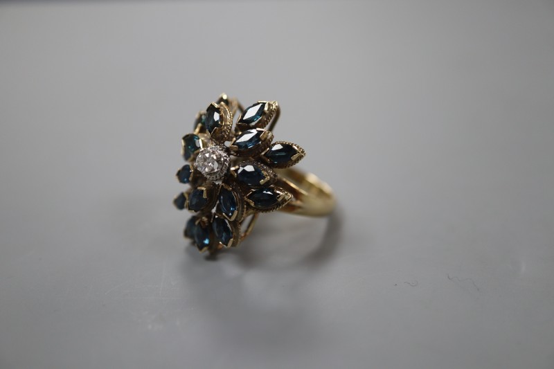 A 14k yellow metal, sapphire and diamond set raised cluster dress ring, of flowerhead design, size M, gross weight 9.2 grams.